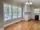 Bright eat in kitchen featuring white cabinets, and hardwood floors at 4016 Berman Edge Rd, Holly Springs, NC 27540