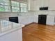 Bright kitchen featuring white cabinetry, subway tile backsplash, quartz countertops, and stainless steel appliances at 4016 Berman Edge Rd, Holly Springs, NC 27540