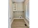 A well-organized laundry room featuring built-in shelving, a countertop, and modern connections at 4016 Berman Edge Rd, Holly Springs, NC 27540