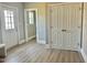 Bright living room featuring hard surface floors, fresh paint, closet and entry doors at 4016 Berman Edge Rd, Holly Springs, NC 27540