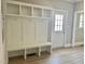 Mudroom featuring built-in bench seating with cubbies and shelves, plus easy access to outside at 4016 Berman Edge Rd, Holly Springs, NC 27540