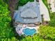 Stunning aerial view of a brick home with a pool, outdoor seating areas, and lush landscaping at 404 Settlecroft Ln, Holly Springs, NC 27540