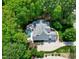 An aerial view of the home, pool, and surrounding mature trees providing privacy at 404 Settlecroft Ln, Holly Springs, NC 27540
