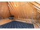 Unfinished attic space with exposed wood beams, flooring, and potential for storage or customization at 404 Settlecroft Ln, Holly Springs, NC 27540