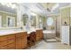 Well-lit bathroom with double vanities, a soaking tub, and a separate glass shower at 404 Settlecroft Ln, Holly Springs, NC 27540
