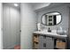 Charming bathroom with shiplap walls, gray vanity, stylish mirror, and decorative baskets for storage at 404 Settlecroft Ln, Holly Springs, NC 27540