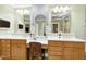Bathroom featuring double sinks, vanity area, framed mirrors, and great lighting at 404 Settlecroft Ln, Holly Springs, NC 27540