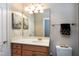 Bathroom with single vanity, framed mirror, and updated lighting at 404 Settlecroft Ln, Holly Springs, NC 27540