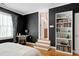This bedroom has black walls with a bookshelf and bathroom access on the opposite wall at 404 Settlecroft Ln, Holly Springs, NC 27540