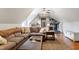 Cozy bonus room with large sectional and exercise equipment at 404 Settlecroft Ln, Holly Springs, NC 27540
