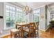 Bright dining area with large windows, hardwood floors, and a chandelier at 404 Settlecroft Ln, Holly Springs, NC 27540