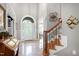 Spacious foyer featuring tile flooring, a staircase, and an elegant front door at 404 Settlecroft Ln, Holly Springs, NC 27540