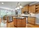 Well-lit kitchen features granite countertops, an island, and stainless steel appliances at 404 Settlecroft Ln, Holly Springs, NC 27540
