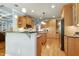Spacious kitchen with wooden cabinets, island, and stainless steel appliances at 404 Settlecroft Ln, Holly Springs, NC 27540