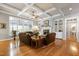Bright living room with coffered ceilings, fireplace, built-ins, and hardwood floors at 404 Settlecroft Ln, Holly Springs, NC 27540