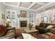 Inviting living room features a fireplace, built-in bookshelves, and coffered ceilings at 404 Settlecroft Ln, Holly Springs, NC 27540
