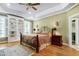 Spacious main bedroom with hardwood floors, built-in shelves, and a decorative ceiling at 404 Settlecroft Ln, Holly Springs, NC 27540