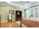 Bright main bedroom featuring hardwood floors, built-in shelves, and stylish furnishings at 404 Settlecroft Ln, Holly Springs, NC 27540