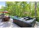 Lovely in-ground pool with lounge area and table, surrounded by lush trees and greenery at 404 Settlecroft Ln, Holly Springs, NC 27540