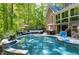 Beautiful in-ground pool with a basketball hoop, patio furniture, and lush landscaping at 404 Settlecroft Ln, Holly Springs, NC 27540