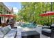 Beautiful in-ground pool and seating area nestled amongst mature landscaping and trees at 404 Settlecroft Ln, Holly Springs, NC 27540