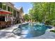 Beautiful in-ground pool with surrounding patio and outdoor dining area at 404 Settlecroft Ln, Holly Springs, NC 27540