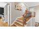 Staircase featuring wood steps, decorative railing, and a landing area at 404 Settlecroft Ln, Holly Springs, NC 27540