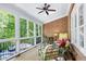 Relaxing sunroom with brick wall, and many windows that let in natural light at 404 Settlecroft Ln, Holly Springs, NC 27540