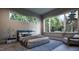 Serene bedroom with large windows offering views of nature and comfortable furnishings at 404 Shinleaf Pond Trl, Raleigh, NC 27614