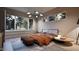 Modern bedroom with large windows offering abundant natural light and views of the surrounding greenery at 404 Shinleaf Pond Trl, Raleigh, NC 27614