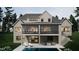 Back exterior view of a two-story home with backyard pool and outdoor seating areas at 404 Shinleaf Pond Trl, Raleigh, NC 27614