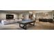 Spacious game room featuring a pool table and comfortable seating area for entertainment at 404 Shinleaf Pond Trl, Raleigh, NC 27614