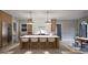 Modern kitchen with large island, breakfast bar, and stainless steel appliances at 404 Shinleaf Pond Trl, Raleigh, NC 27614