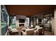 Inviting outdoor living space with fireplace, multiple seating areas, and serene views at 404 Shinleaf Pond Trl, Raleigh, NC 27614