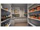 Spacious pantry with ample shelving, counter space, storage baskets, and a convenient sink at 404 Shinleaf Pond Trl, Raleigh, NC 27614