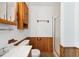 Bathroom featuring natural wood paneled walls and cabinet storage at 409 Ivey Rd, Graham, NC 27253