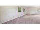 Bright and airy bedroom with neutral carpet and walls, enhanced by plenty of natural light from multiple windows at 409 Ivey Rd, Graham, NC 27253
