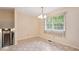 Well-lit dining room with patterned floors, a chandelier, and a view of the backyard at 409 Ivey Rd, Graham, NC 27253