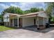 Charming exterior featuring brick accents, covered porch, and a convenient carport area for parking at 409 Ivey Rd, Graham, NC 27253