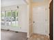 Inviting foyer with large windows, a patterned tile floor, and a view of the living area at 409 Ivey Rd, Graham, NC 27253