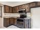 Modern kitchen with granite countertops, stainless steel microwave, and range, complemented by ample cabinets at 409 Ivey Rd, Graham, NC 27253