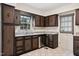 This kitchen features a stainless steel dishwasher and granite countertops at 409 Ivey Rd, Graham, NC 27253