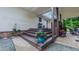 Covered porch with wooden stairs and vibrant flowers in decorative planters at 41 Maple Cir, Pittsboro, NC 27312