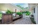 Covered porch with wooden floors, bench seating, and views of the shed and RV at 41 Maple Cir, Pittsboro, NC 27312