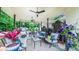 Covered patio boasting ample seating, ceiling fans, and lush plants for outdoor comfort at 41 Maple Cir, Pittsboro, NC 27312