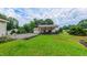 Scenic backyard view featuring a patio with seating and lush green lawn with beautiful garden at 41 Maple Cir, Pittsboro, NC 27312