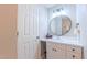 Bathroom with vanity, white cabinets and countertop, and round mirror at 41 Maple Cir, Pittsboro, NC 27312