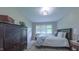 Cozy bedroom featuring neutral paint, a window, and dark wood furniture at 41 Maple Cir, Pittsboro, NC 27312
