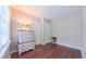 Bedroom with wood flooring, a dresser, and a window for natural light at 41 Maple Cir, Pittsboro, NC 27312