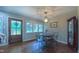 Cozy dining room featuring hardwood floors, a stylish chandelier, and plenty of natural light from large windows at 41 Maple Cir, Pittsboro, NC 27312